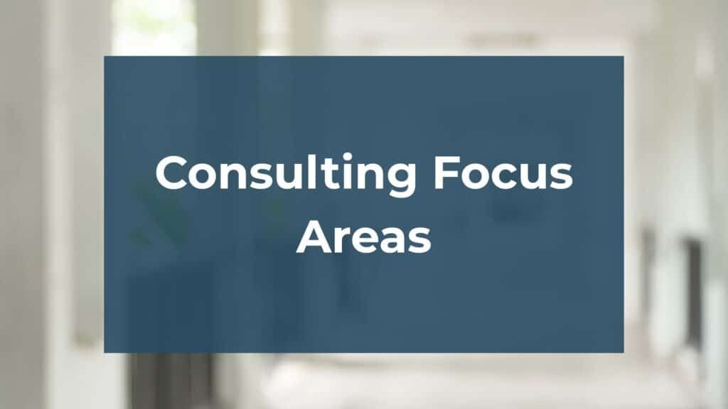 A blue rectangle with white text reading "Consulting Focus Areas" is centered on a blurred, light-colored background.