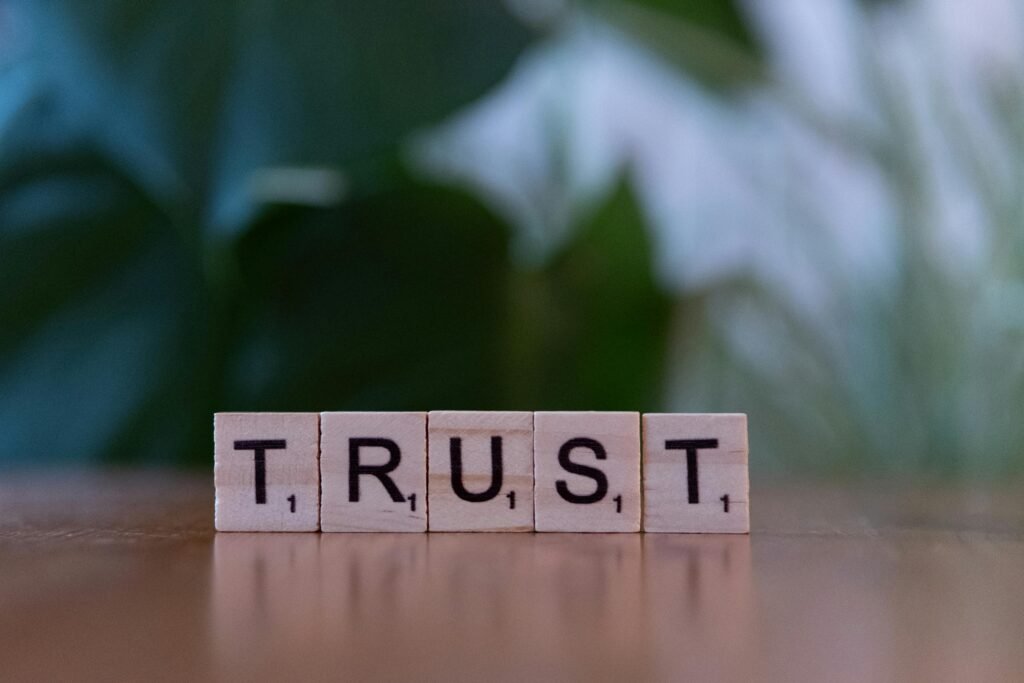pexels-photo-30945292-30945292 - Tapestry AG Wooden letter tiles spelling TRUST on a wooden surface, symbolizing integrity and values.